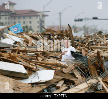Michelle Ricketson surveys the debris that came ashore from Hurricane Ike in Galveston, Texas on September 13, 2008. Hurricane Ike hit the Texas coast early today. (UPI Photo/Aaron M. Sprecher) Stock Photo