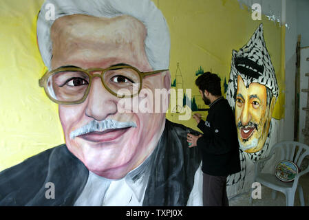 A Palestinian artist works on a wall picturing Palestine Liberation Organization Chairman Mahmoud Abbas on  December 25, 2004, in Gaza City. Palestine Liberation Organization Chairman Mahmoud Abbas called on Israel to completely withdraw from the West Bank and Gaza Strip. ( UPI Photo/Ismael Mohamad ) Stock Photo