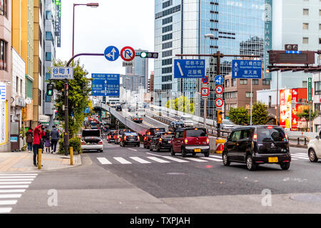 Osaka, Japan - April 13, 2019: View of downtown traffic jam closeup with road signs and hotel Stock Photo
