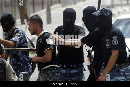 Palestinian Security forces from Hamas arrest members of the Fatah movement during clashes in Rafah in southern Gaza  on September 7, 2007. Security forces from the Hamas Islamist movement clashed with protesters in the Gaza Strip on Friday, as members of the rival Fatah faction gathered to pray in defiance of a ban imposed on open-air gatherings.   (UPI Photo/Ismael Mohamad) Stock Photo