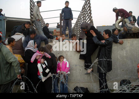 Palestinians cross into Egypt through the Rafah border after the barrier wall was destroyed yesterday by Palestinian militants on January 24, 2008 in Gaza. (UPI Photo/Ismael Mohamad) Stock Photo