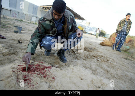 Palestinian policeman inspect around a police station following an Israeli air raid in Khan Yunis, southern Gaza on February 5, 2008. Israeli strikes on the Gaza Strip killed 7 Hamas policemen.  (UPI Photo/Ismael Mohamad) Stock Photo