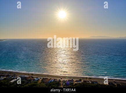 the sun shines brightly over the sea on a cloudless summer day Stock Photo