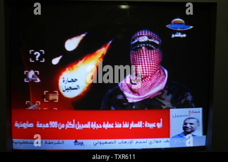 Abu Obaida, the spokesman for the Ezzedine Al-Qassam Brigades, the armed wing of Hamas, speaks on Hamas TV (AL-aqsa) November 18, 2012.  Israel bombed  targets in Gaza for a fifth straight day on Sunday  injuring at least six journalists, as a separate raid in northern Gaza killed two people, Palestinian medical sources said. UPI/Ismael Mohamad Stock Photo