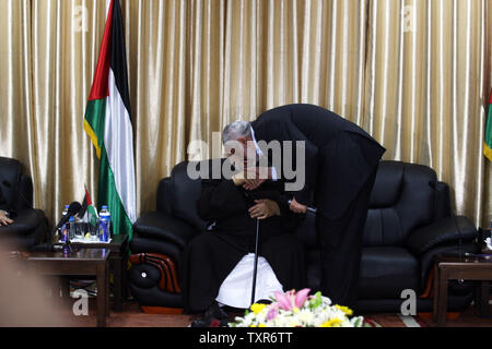 Hamas Prime Minister Ismail Haniyeh (L) kisses the hand of Egyptian Cleric and chairman of the International Union of Muslim Scholars, Sheikh Yusuf al-Qaradawi upon al-Qaradawi's arrival at Rafah Crossing in the southern Gaza Strip May 8, 2013. Al-Qaradawi arrived on May 8, 2013 for a three-day visit to Gaza Strip with a delegation of Muslim scholars. UPI/Ismael Mohamad Stock Photo