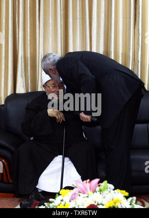 Hamas Prime Minister Ismail Haniyeh (L) kisses the haed of Egyptian Cleric and chairman of the International Union of Muslim Scholars, Sheikh Yusuf al-Qaradawi upon al-Qaradawi's arrival at Rafah Crossing in the southern Gaza Strip May 8, 2013. Al-Qaradawi arrived on May 8, 2013 for a three-day visit to Gaza Strip with a delegation of Muslim scholars. UPI/Ismael Mohamad Stock Photo