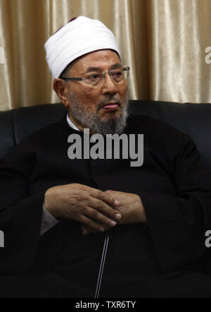 Egyptian Cleric and chairman of the International Union of Muslim Scholars Sheikh Yusuf al-Qaradawi , upon al-Qaradawi's arrival at Rafah Crossing in the southern Gaza Strip May 8, 2013. Al-Qaradawi arrived on May 8, 2013 for a three-day visit to Gaza Strip with a delegation of Muslim scholars. UPI/Ismael Mohamad Stock Photo