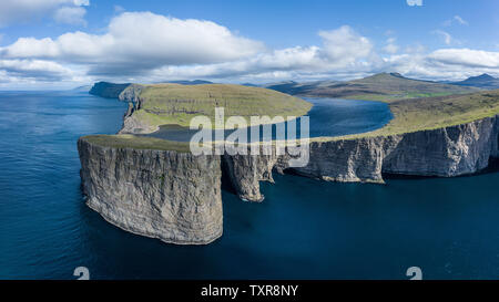 Leitisvatn lake and Tralanipan, slave rock, near Bosdalafossur waterfall on Vagar island, Faroe Islands Stock Photo