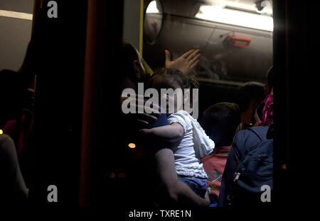 Migrants disembark from the passenger ship 'Tera Jet', following their trip from the island of Lesbos to the port of Piraeus, near Athens, Greece on September 1, 2015. Another 1,700 migrants arrived aboard the ferry to Piraeus from the island of Mytilene, migrants arriving on its eastern Aegean islands, with more than 160,000 landing so far this year. Europe is struggling to respond to its biggest migration crisis since World War II, with more than 300,000 people arriving this year. photo by Yuksel Pecenek/ UPI Stock Photo