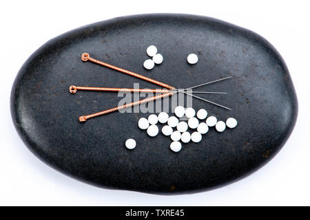 Alternative medicine with homeopathic pills and acupuncture Stock Photo