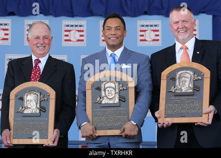 Newly elected members to the National Baseball Hall of Fame (L to R) Pat Gillick, Roberto Alomar and Bert Blyleven hold their new placques following induction ceremonies in Cooperstown, New York on July 24, 2011.   UPI/Bill Greenblatt Stock Photo