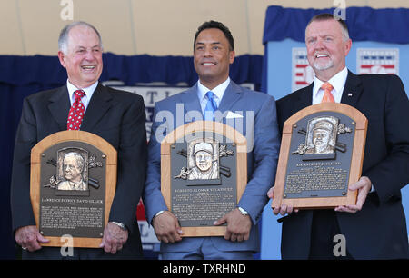 Newly elected members to the National Baseball Hall of Fame (L to R) Pat Gillick, Roberto Alomar and Bert Blyleven hold their new placques following induction ceremonies in Cooperstown, New York on July 24, 2011.   UPI/Bill Greenblatt Stock Photo