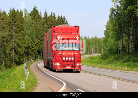 Jyvaskyla, Finland. June 7, 2019. Beautifully customized new red Scania R truck with full trailer of Konnekuljetus Oy hauls goods along highway. Stock Photo