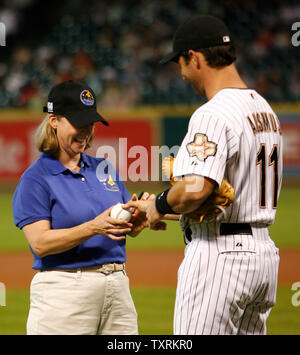 NASA Astronaut and Shuttle STS-120 commander Pamela A. Melroy (L) has her ball autographed by Houston Astros catcher Brad Ausmus (R) prior to the Los Angeles Dodgers vs. Houston Astros game at Minute Maid Park in Houston on July 24, 2007. The Astros hosted their annual NASA Night at Minute Maid Park to recognize the seven NASA astronauts that will be traveling into outer space aboard the Shuttle STS-120. Stock Photo