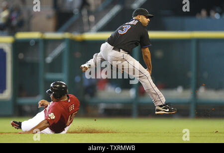 New York Mets shortstop Alex Cora (R) leaps over Houston Astros left fielder Carlos Lee (L) to complete a double play in the ninth inning at Minute Maid Park in Houston, Texas on July 26, 2009. The Mets defeated the Astros 8-3. (UPI Photo/Aaron M. Sprecher) Stock Photo