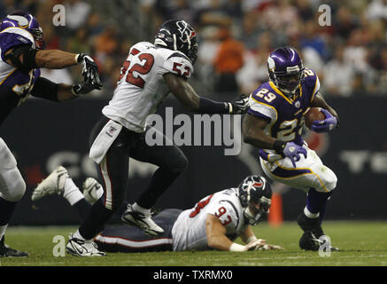 FILE- In this file photo taken Aug. 25, 2010, in Seattle, Minnesota Vikings  running back Chester Taylor runs pushing off Seattle Seahawks' Chuck Darby.  Taylor, who is now with the Chicago Bears