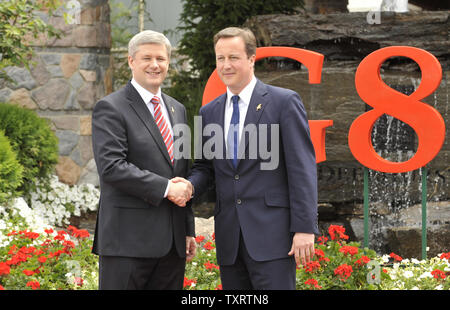 Canadian Prime Minister Stephen Harper (L) welcomes Britain's Prime Minister David Cameron to the G8 Summit at Deerhurst Resort in Huntsville, Ontario on June 25, 2010. UPI Photo/Alex Volgin Stock Photo