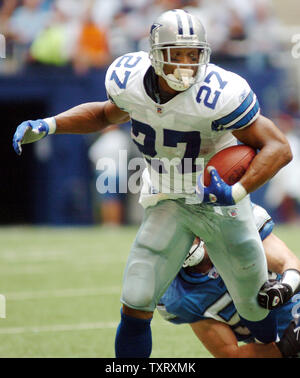 Dallas running back Eddie George escapes the grasp of a Detroit