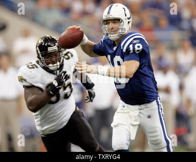 Indianapolis Colts quarterback Peyton Manning (18) passes the ball under pressure from Jacksonville defender Paul Spicer (95). The Indianapolis Colts defeated the Jacksonville Jaguars 10-3 at the RCA Dome in Indianapolis, Indiana, September 18, 2005. (UPI Photo/Mark Cowan) Stock Photo