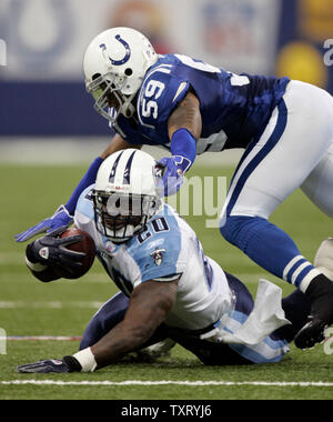 Tennessee Titans running back Travis Henry (#20) gives Philadelphia Eagles  cornerback Sheldon Brown (#24) a stiff arm to keep him away as he runs for  43 yards to the Philadelphia 16-yard line