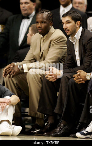Indiana Pacers leading scorer Jermaine O'Neal, left, talks with newly traded forward Peja Stojakovic during the first half of the Pacers game against the Cleveland Cavaliers at Conseco Fieldhouse in Indianapolis on January 27, 2006. O'Neal injured his groin and will be out up to 8 weeks and Stojakovic has not been activated since being traded last week from the Sacramento Kings for Ron Artest. (UPI Photo/Mark Cowan) Stock Photo