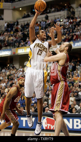 Indiana Pacer David Harrison (13) shoots over Cleveland Cavaliers center Zydrunas Ilgauskas (11) as teammate Drew Gooden (90) looks on in the second half of the Cavaliers 93-89 win at Conseco Fieldhouse in Indianapolis, In January 27, 2006. (UPI Photo/Mark Cowan) Stock Photo