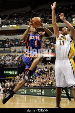 New York Knicks guard Steve Francis (1) goes up for a basket in front of Indiana Pacers center David Harrison (13) in the first half at Conseco Fieldhouse in Indianapolis, In March 7, 2006. (UPI Photo/Mark Cowan) Stock Photo