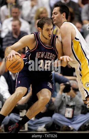 New Jersey Nets forward Nenad Kristic (12) drives to the basket against Indiana Pacers defender Jeff Foster (10) in game 3 of their first round playoff series at Conseco Fieldhouse in Indianapolis, In April 27, 2006. (UPI Photo/Mark Cowan) Stock Photo