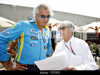 Renault team Principal director Flavio Briatore, left talks with Formula One president Bernie Ecclestone before the start of the Formula One USGP at the Indianapolis Motor Speedway in Indianapolis on July 2, 2006. (UPI Photo/Tom Russo) Stock Photo