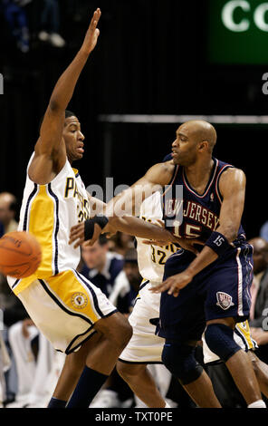 New Jersey Nets guard Vince Carter (15) passes the ball around Indiana Pacers guard Danny Granger (33) at Conseco Fieldhouse in Indianapolis November 17, 2006. (UPI Photo/Mark Cowan) Stock Photo