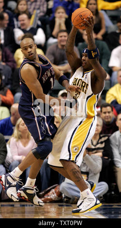 Indiana Pacers center Al Harrington (32) pulls down a rebound in front of New Jersey Nets guard Vince Carter (15) at Conseco Fieldhouse in Indianapolis November 17, 2006. The New Jersey Nets defeated the Indiana Pacers 100-91. (UPI Photo/Mark Cowan) Stock Photo