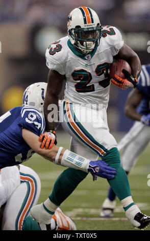 Miami Dolphins running back Ronnie Brown (23) fights off Indianapolis Colts line backer Rob Morris (94) for a first down at the RCA Dome in Indianapolis on December 31, 2006. (UPI Photo/Mark Cowan) Stock Photo