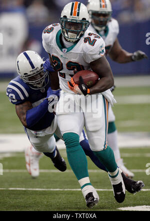 Miami Dolphins running back Ronnie Brown is brought down by Denver Broncos  cornerback Dre Bly in the fourth quarter in Denver, Colorado, Sunday,  November 2, 2008. The Dolphins defeated the Broncos 26-17. (