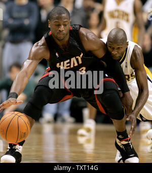 Miami Heat guard Dwyane Wade (3) works to keep the ball away from Indiana Pacers guard Darrell Armstrong (24) at Conseco Fieldhouse in Indianapolis January 24, 2007. The Pacers won 96-94 in overtime. (UPI Photo/Mark Cowan) Stock Photo