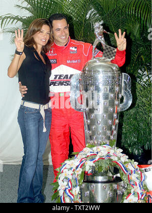 Three-time Indianapolis 500 winner Helio Castroneves and his fiance Adriana Henao pose with the Borg Warner Trophy on May 25, 2009 at the Indianapolis Motor Speedway in Indianapolis, Indiana. (UPI Photo/Mike Bryand) Stock Photo