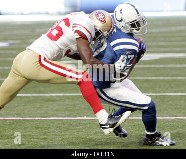 Indianapolis Colts wide receiver Reggie Wayne (87) is hit by San Francisco 49ers cornerback Shawntae Spencer (36) during the first quarter at Lucas Oil Field in Indianapolis on November 1, 2009. UPI /Mark Cowan Stock Photo