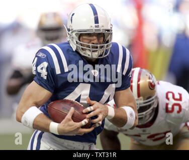 Indianapolis Colt's Dallas Clark (44) is hit by Denver Bronco Anton Palepoi  (95 in the AFC wild card playoff at the RCA Dome in Indianapolis, IN on  January 9, 2005. The Indianapolis