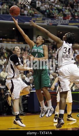 Notre Dame Fighting Irish guard Skylar Diggins (4) lays-up a shot between Texas A&M Aggies defenders Maryann Baker (15) and Karla Gilbert (34) in the first half of the NCAA Women's national championship game at Conseco Fieldhouse in Indianapolis on April 5, 2011.  UPI /Mark Cowan Stock Photo