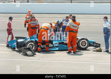Safety team members help rookie Bryan Clauson out of his wrecked racer after slamming the south chute wall into turn 2 on Pole Day May 19, 2012 in Indianapolis, Indiana.     UPI/Don Figler Stock Photo