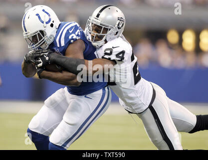 Oakland Raiders safety Charles Woodson (24) brings down Indianapolis Colts running back Vick Ballard (33) after a 7-yard gain in the second quarter at Lucas Oil Field in Indianapolis, Indiana on September 9, 2013.  UPI/Mark Cowan Stock Photo