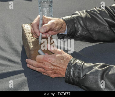 Four time winner Al Unser signs a brick during Legends Day  of the Indianapolis 500 at the Indianapolis Motor Speedway  on May 23, 2015 in Indianapolis, Indiana. Photo by Scott Paceley/UPI Stock Photo