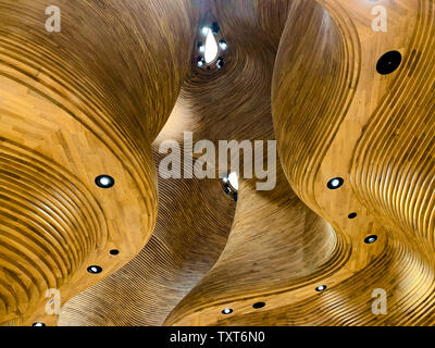 Wooden, dynamic and organic ceiling of the National Museum shop. April 2019, Doha. Stock Photo