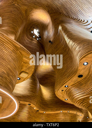 Wooden, dynamic and organic ceiling of the National Museum shop. April 2019, Doha. Stock Photo