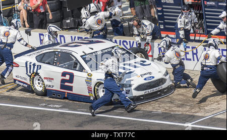 The nearly acrobatic crew of Brad Keselowski's Miller Lite Ford (2) work during second pit for him during the 23rd Brickyard 400 at the Indianapolis Motor Speedway on July 24, 2016 in Indianapolis, Indiana.    Photo by Ed Locke/UPI Stock Photo