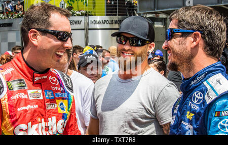 Kyle Busch (left to right), Singer Brantley Gilbert, and Martin Truex Jr. chat prior to the start of the 2017 Brantley Gilbert Big Machine Brickyard 400,  at the Indianapolis Motor Speedway on July 23, 2017 in Indianapolis, Indiana. Photo by Edwin Locke/UPI Stock Photo