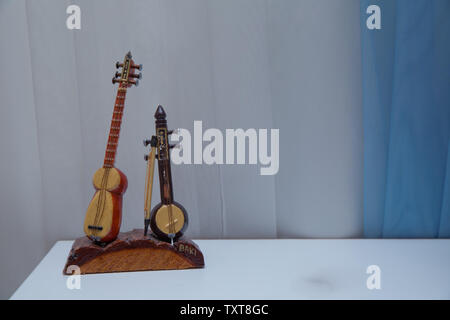 East music instruments on the rug .Tar string instrument . Kamancha, Kamanche, Kemancheh, Kamanjah, Kabak kemane . Souvenir Tar and Kamancha. Stock Photo