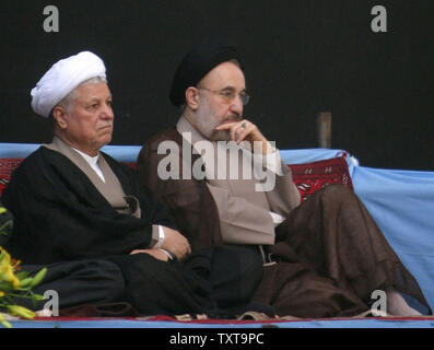 Iranian President Mohammad Khatami (R)and presidential front-runner and former president Akbar Hashemi Rafsanjani sit next to each other during a ceremony to mark the 16th anniversary of the death of the late leader Ayatollah Ruhollah Khomeini at his mausoleum south of Tehran June 4, 2005. Iran's supreme leader Ayatollah Ali Khamenei called for a high turnout in the June 17 presidential polls as a sign of continued popular support for the country's clerical establishment.(UPI Photo/Mohammad Rezaei) Stock Photo