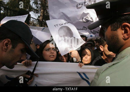 Iranian women hold posters in support of Iran's leading investigative journalist, Akbar Ganji,who is jailed for articles linking government officials to murder, during a demonstration, outside Tehran University, in Tehran, Iran, Tuesday, July 12, 2005.   (UPI Photo) Stock Photo