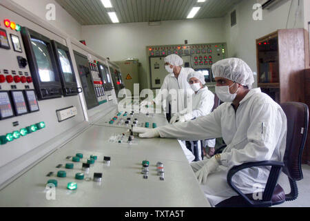 Technicians of Iran's Atomic Energy Organization are shown in a control room to supervise the resumption of activities at the Uranium Conversion Facility in Isfahan, Iran on August 8, 2005. United Nations inspectors watched as Iran removed the final seals from equipment at a uranium conversion plant on August 10, 2005.   Iran is ignoring European and U.S. calls to keep the nuclear facility closed.   (UPI Photo/Str) Stock Photo