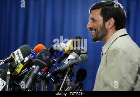 Iran's president Mahmoud Ahmadinejad smiles behind a bank of microphones during a press conference in Tehran, Iran on January 14, 2006.  Iran will not be deflected from its right to develop nuclear technology by referral to the UN Security Council for possible sanctions, Iranian President Mahmoud Ahmadinejad said on Saturday.    (UPI Photo/Mohammad Kheirkhah) Stock Photo